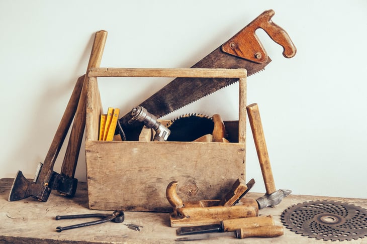 Old wooden box full of vintage carpentry tools.