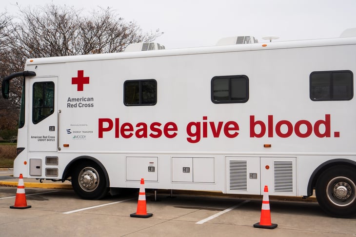 American Red Cross Blood Service vehicle parked outdoors for people to volunteer and donate their blood.