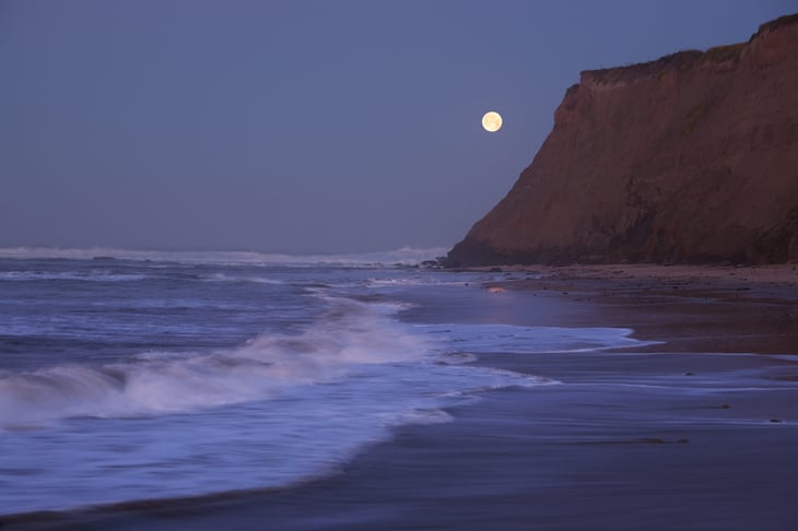 Moon over a Half Moon Bay cliffside.