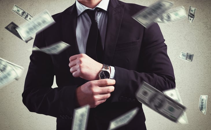 A wealthy man surrounded by money.