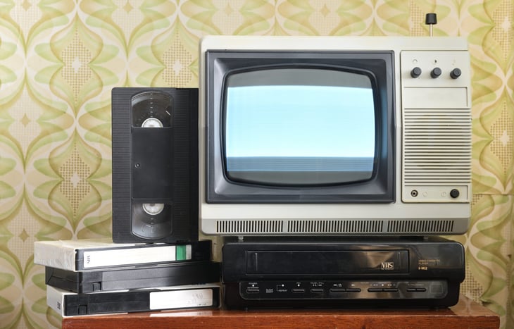 Old television with VCR and VHS tapes.