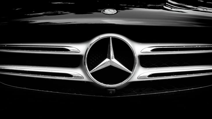 The front of a Mercedes-Benz with logo.
