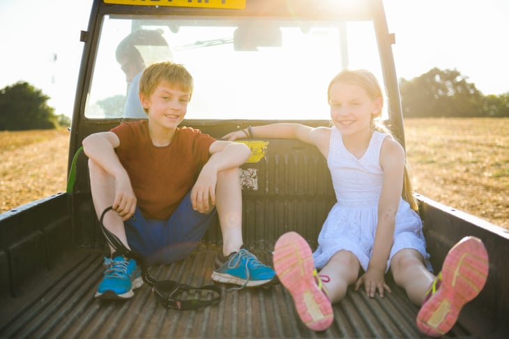 Kids in the bed of a pickup truck