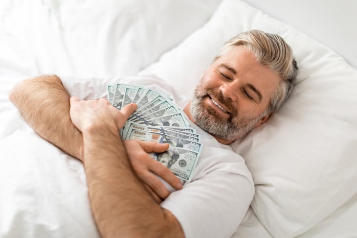 A man sleeping with money on his chest