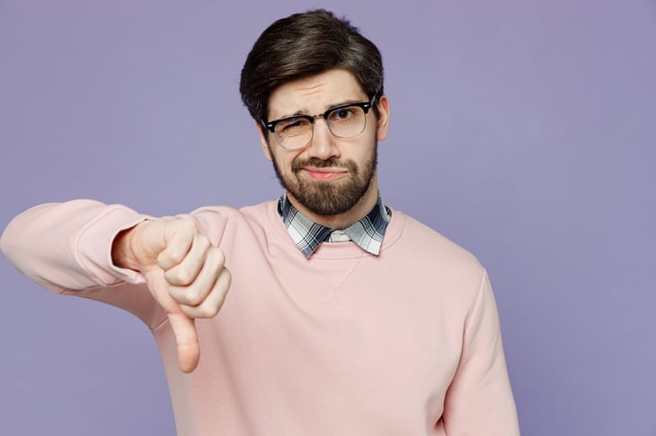 thumbs down unhappy man