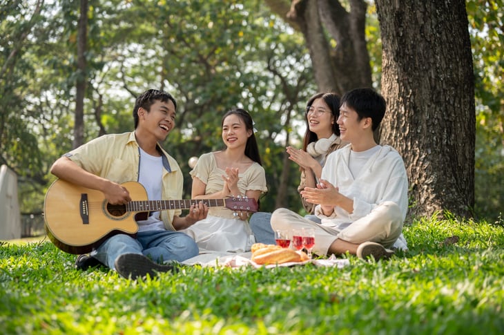 A group of friends singing together in a public park