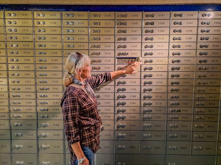 A woman opens her safe deposit box