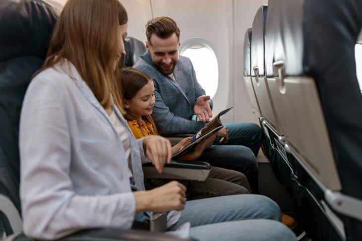 Man and woman traveling with daughter on an airplane