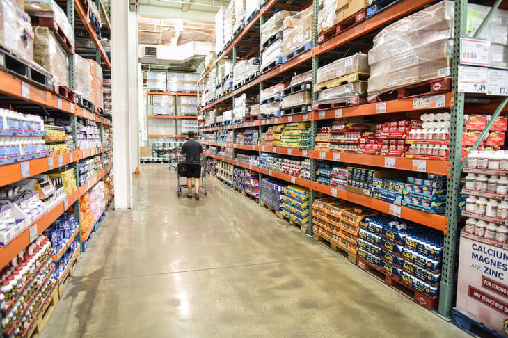 Costco shopper going down the aisle with a shopping cart