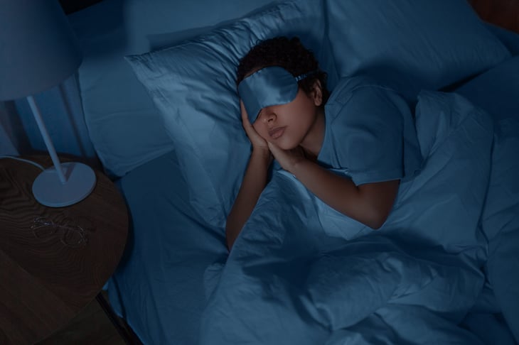 Woman sleeping with an eye mask.
