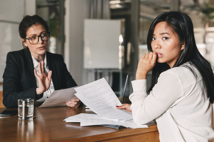 Nervous job candidate looking at her resume