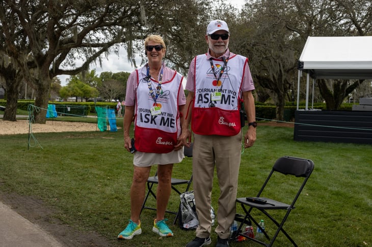 Volunteers pose for a photo at Bay Hill during the Arnold Palmer Invitational practice rounds