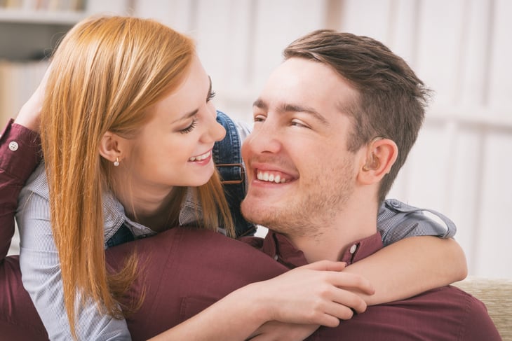 A happy couple, man with hearing aids.