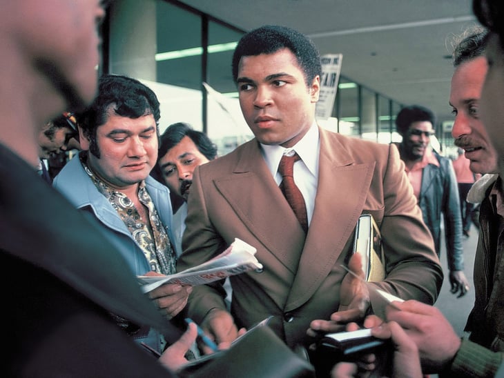 Muhammad Ali signs autographs for fans at the San Antonio International Airport in 1979.