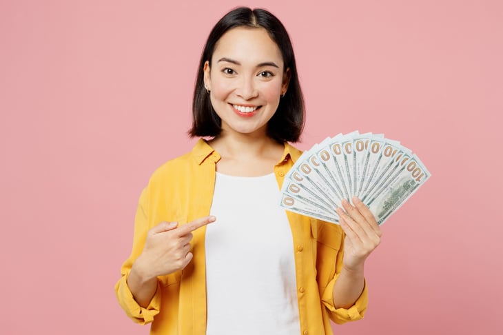 woman pointing to money