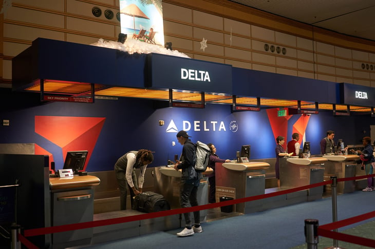 Traveler at the Delta Air Lines desk at an airport