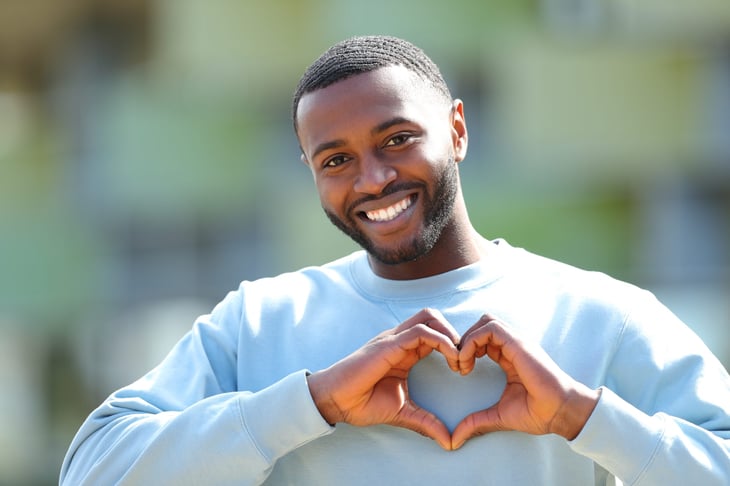 Man making the heart symbol with his hands