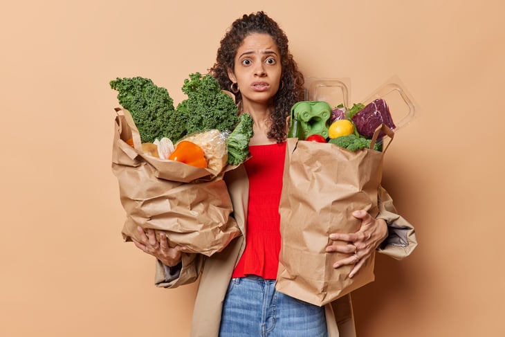 A woman with bags full of groceries.