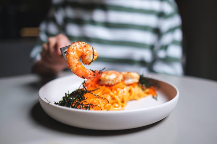 Woman eating shrimp