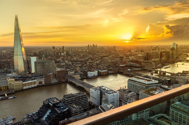London, UK. Sky Garden with a view of The Shard, Tower Bridge, London's skyline, and the River Thames at sunset.