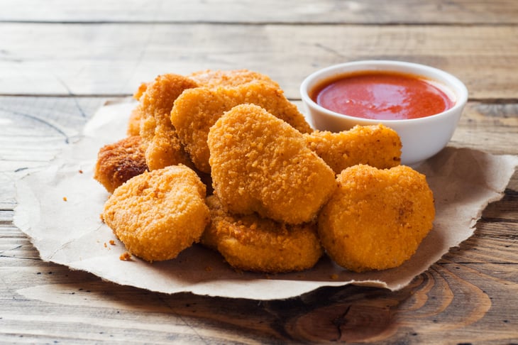 Chicken nuggets with ketchup.