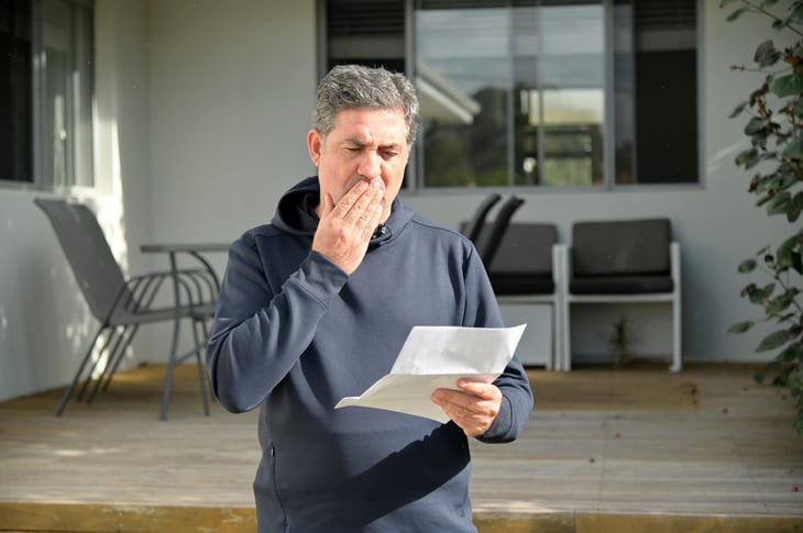 Surprised homeowner looks at bill