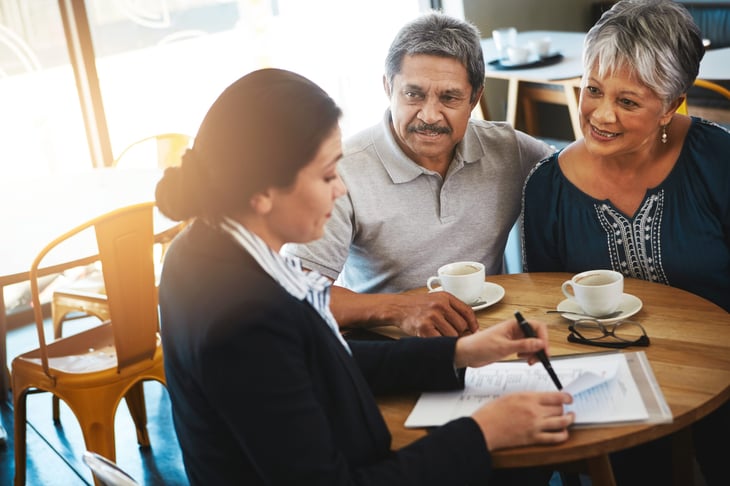 Senior couple meeting with a lawyer to go over legal documents.