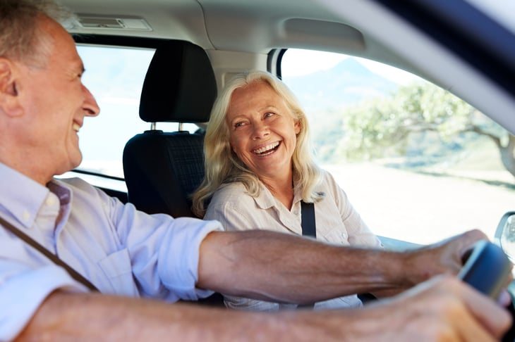 Happy senior couple driving.