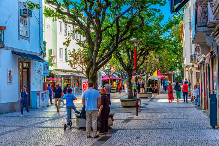 People strolling through narrow street of historical center of Braga, Portugal