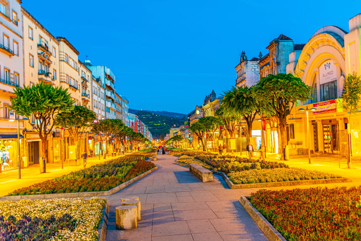 Sunset view of people strolling on Avenida da Liberdade in the historical center of Braga, Portugal