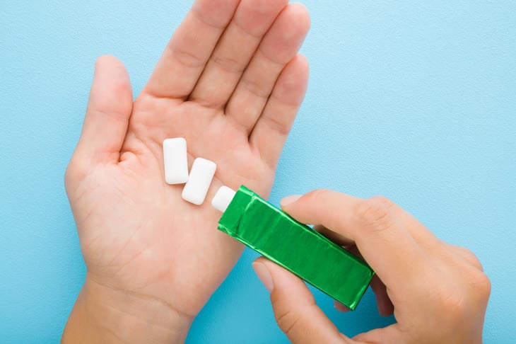 Pouring out sugar-free gum.