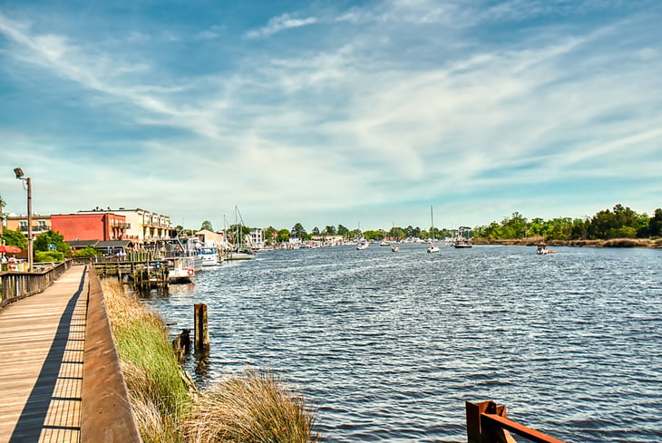 The boardwalk along the river in Georgetown, SC with the marina in the background.