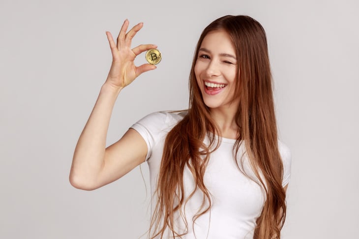 Woman holding Bitcoin cryptocurrency