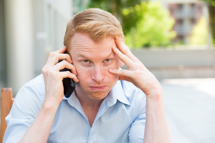 Frustrated caller waiting on hold