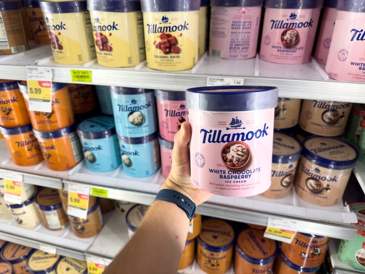 Tillamook company creamy White Chocolate Raspberry ice cream inside a freezer section of a grocery store.