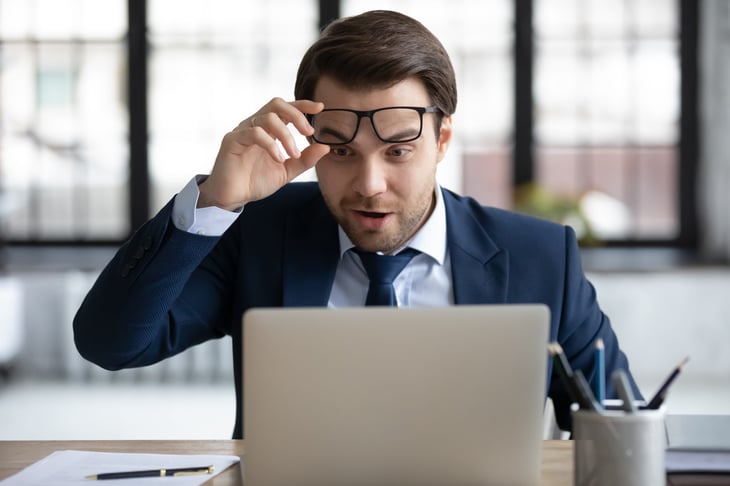 Happy worker looking at his portfolio on his computer