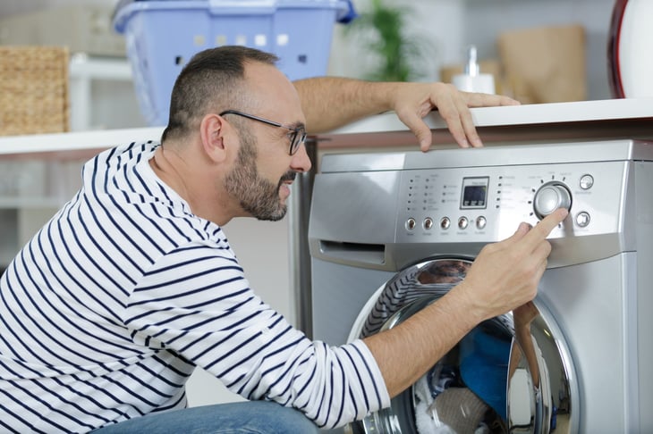Man using a washing machine