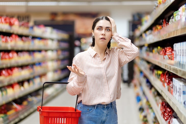 Woman shopping and worried about higher prices