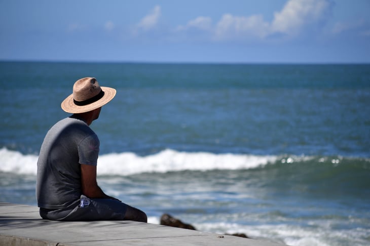 A young man looks at the sea in Mazatlán-Mexico.