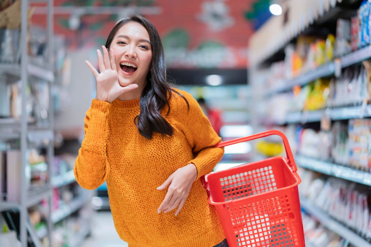Happy woman who is grocery shopping