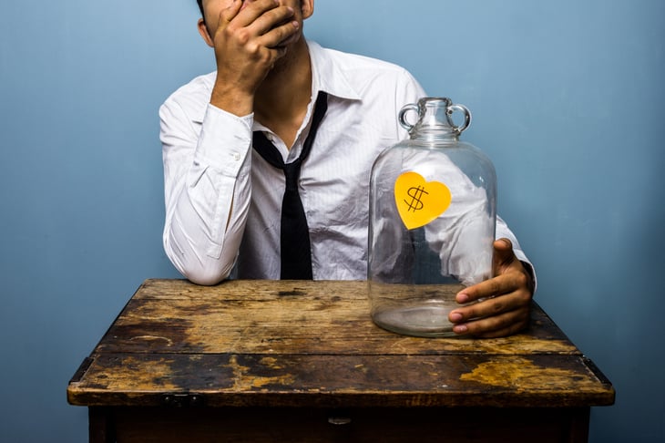 Man with empty money jar