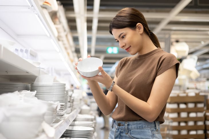 A woman shops for dishes at a restaurant supply store