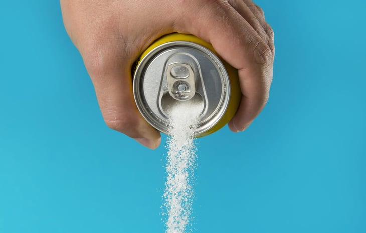 Can pouring out sugar or artificial sweetener.