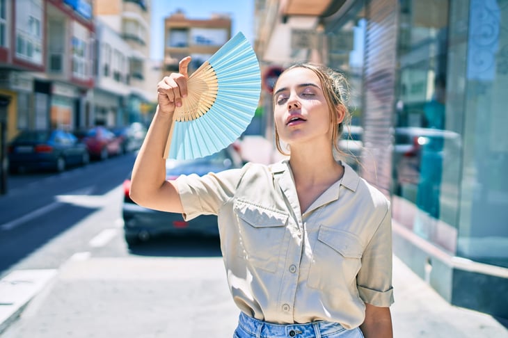 Woman trying to cool down in the heat