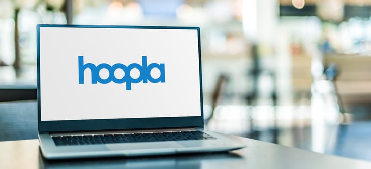 Laptop computer displaying logo of Hoopla, a web and mobile library media streaming platform for audio books, comics, e-books, movies, music, and TV
