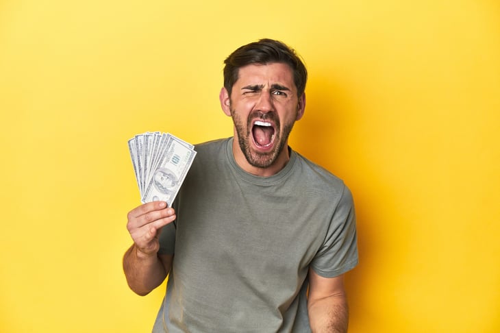 Upset man holding money