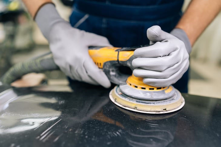 Factory or mechanc worker grinding metal