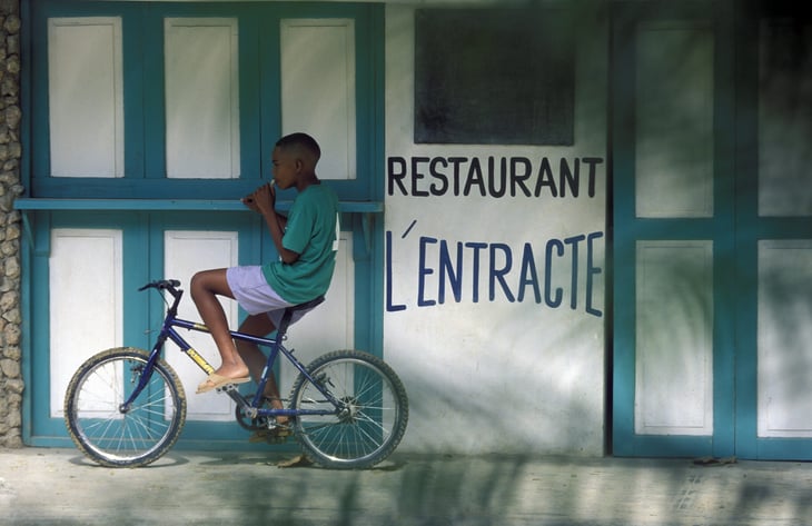 Boy on a bike in the village of Las Terrenas on Samana at Dominican Republic in the Caribbean Sea in Latin America.