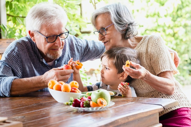 Grandparents eating with grandkid.