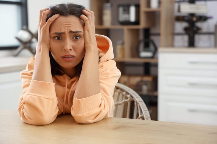 Scared woman at home alone